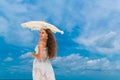 Beautiful young woman in white dress with umbrella on a tropical Royalty Free Stock Photo