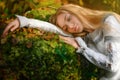 Beautiful young woman in a white dress in the middle of a forest Royalty Free Stock Photo