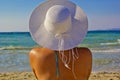 Beautiful young woman in a white hat on the beach Royalty Free Stock Photo
