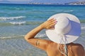 Beautiful young woman in a white hat on the beach Royalty Free Stock Photo