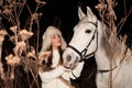 Beautiful young woman with white horse outdoors Royalty Free Stock Photo