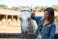 Beautiful young woman with a white horse Royalty Free Stock Photo