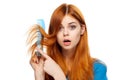 Beautiful young woman on white isolated background holds a hairbrush, hair cut Royalty Free Stock Photo