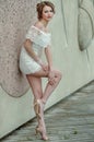Beautiful young woman in white lace dress posing outdoors. Royalty Free Stock Photo