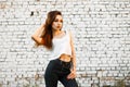 Beautiful young woman in a white T-shirt and black jeans Royalty Free Stock Photo