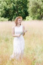 Beautiful young woman in white vintage lace dress with hat Royalty Free Stock Photo