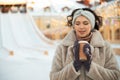 Beautiful young woman in winter clothes at christmas market drinking coffee Royalty Free Stock Photo