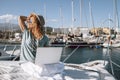 Beautiful young woman work with laptop computer in alternative office boat at the dock - happy alternative people enjoying smart Royalty Free Stock Photo