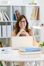 Beautiful young woman working with her laptop at home. Royalty Free Stock Photo