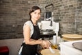 Beautiful young woman working in pizza shop with raw dough Royalty Free Stock Photo