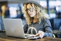 Beautiful young woman working with roaming phone device like digital travel nomad or smart work at the bar cafe - modern people