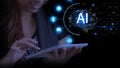 Beautiful young woman working with tablet with AI artificial intelligence interface. AI hologram with chatbot and online Royalty Free Stock Photo
