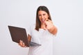 Beautiful young woman working using computer laptop over white background pointing to you and the camera with fingers, smiling Royalty Free Stock Photo