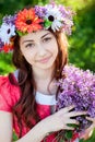 Beautiful young woman with wreath flowers in the spring garden Royalty Free Stock Photo