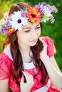 Beautiful young woman with wreath flowers in the spring garden Royalty Free Stock Photo