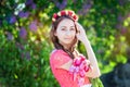 Beautiful young woman with wreath flowers walking in the garden Royalty Free Stock Photo