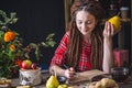 Beautiful young woman writes autumn dreams in a notebook. Fall table with flowers. Concept of autumn romantic mood Royalty Free Stock Photo