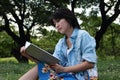 Beautiful young woman writing outdoors in a park Royalty Free Stock Photo