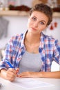 Beautiful young woman writing something in her note pad Royalty Free Stock Photo