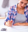 Beautiful young woman writing something in her note pad Royalty Free Stock Photo