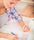 Beautiful young woman writing something in her note pad Royalty Free Stock Photo