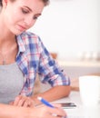 Beautiful young woman writing something in her note pad Royalty Free Stock Photo