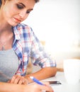 Beautiful young woman writing something in her note pad Royalty Free Stock Photo