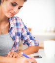 Beautiful young woman writing something in her note pad Royalty Free Stock Photo