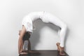 Beautiful young woman in yoga posing in asana on a studio background Royalty Free Stock Photo