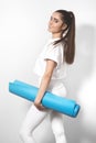 Beautiful young woman in yoga posing on a studio background. Perfect shapes, fit and strong body Royalty Free Stock Photo