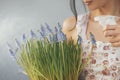 Woman Holding Bouquet of Flowers in Hands Indoors