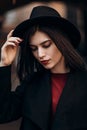 Beautiful young woman in a black coat and hat Royalty Free Stock Photo