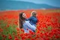 Beautiful young woman with child girl in poppy field. happy family having fun in nature. outdoor portrait in poppies. mother with Royalty Free Stock Photo