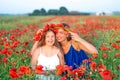 Elegant young woman with child girl in poppy field, happy family having fun in nature, summer time Royalty Free Stock Photo