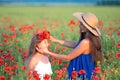 elegant young woman with child girl in poppy field, happy family having fun in nature, summer time Royalty Free Stock Photo