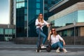Beautiful young women is enjoying sunny summer day while riding around the city on electro kick scooters. Lifestyle. Royalty Free Stock Photo