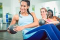 Beautiful woman exercising Russian twist with med ball for strong abs Royalty Free Stock Photo