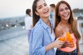 Beautiful women friends on the balcony having fun at party.