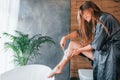 Shaves legs. Beautiful young woman have free time at home in the bath. Royalty Free Stock Photo