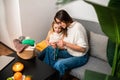 Young woman knitting with her daughter in cozy living room at home Royalty Free Stock Photo