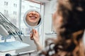 Beautiful young woman looking at mirror with smile in dentist s office Royalty Free Stock Photo