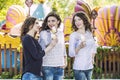 Beautiful young women smiling eating ice-cream and talking in th