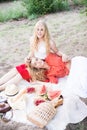 Beautiful young women talking, smiling and gesturing while having picnic outdoors at park. Royalty Free Stock Photo