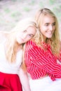 Beautiful young women talking, smiling and gesturing while having picnic outdoors at park. Royalty Free Stock Photo