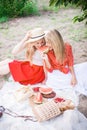 Beautiful young women talking, smiling and gesturing while having picnic outdoors at park. Royalty Free Stock Photo