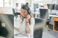 Beautiful young woman telephone operator agent talking using headset in customer support helpline centre. Royalty Free Stock Photo