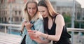 Beautiful young women watching photos on a mobile phone. Royalty Free Stock Photo