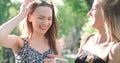 Beautiful young women watching photos on a phone.