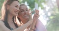 Beautiful young women watching photos on a phone.