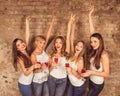 Beautiful young women wearing dress code celebrating hen-party with sparkling wine Royalty Free Stock Photo